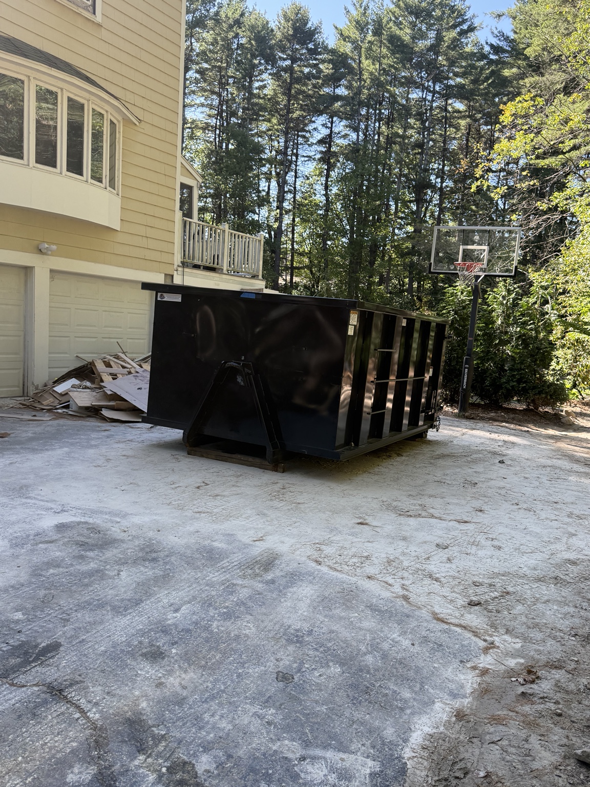 Black 18 yard R&D rental dumpster at a residential cleanout